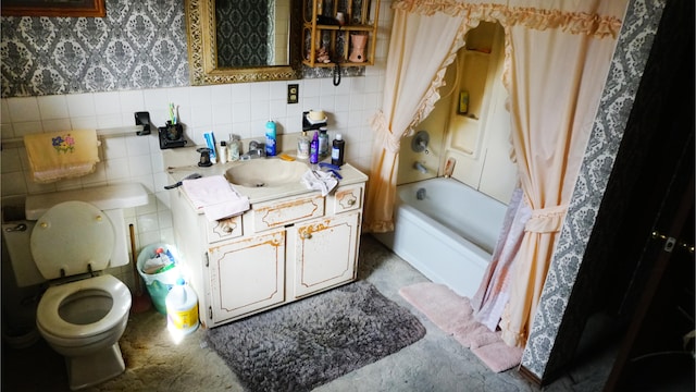 full bathroom featuring shower / tub combo with curtain, tile walls, vanity, and toilet