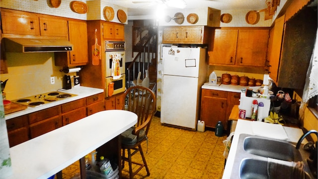 kitchen featuring white appliances and sink