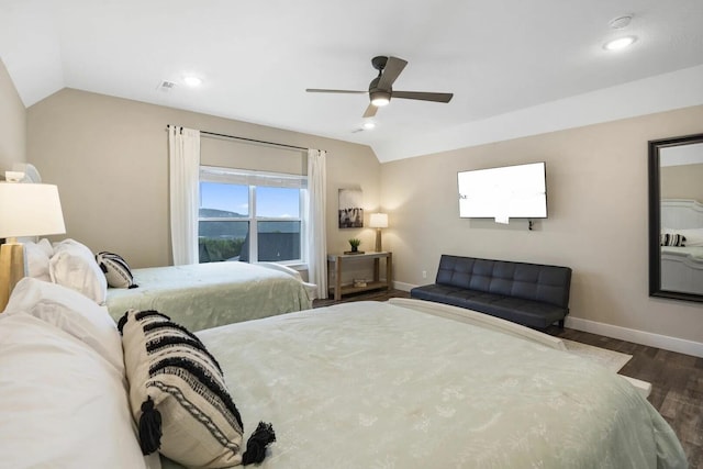 bedroom with ceiling fan, lofted ceiling, and dark wood-type flooring