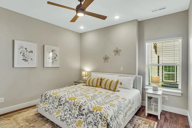 bedroom with hardwood / wood-style floors and ceiling fan