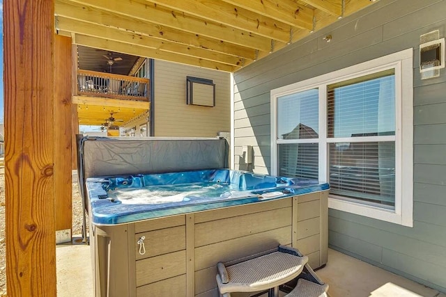 view of patio with ceiling fan and a hot tub