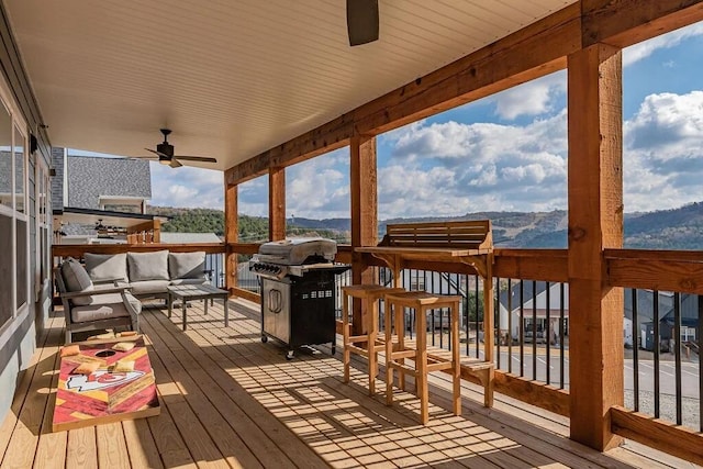 deck featuring outdoor lounge area and ceiling fan