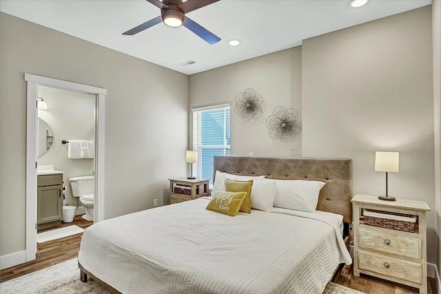 bedroom with ceiling fan, hardwood / wood-style flooring, and ensuite bathroom