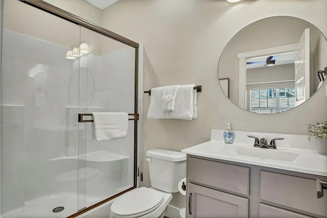 bathroom with vanity, walk in shower, and toilet