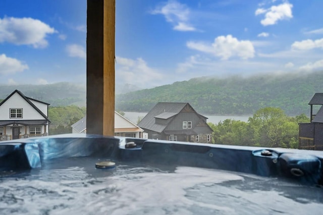 view of swimming pool featuring a water and mountain view