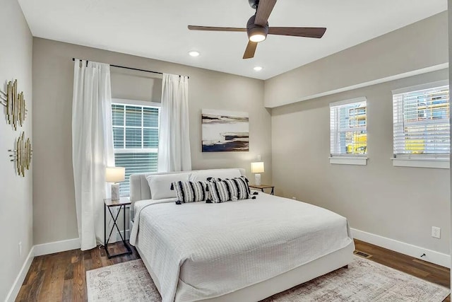 bedroom with ceiling fan and dark hardwood / wood-style floors