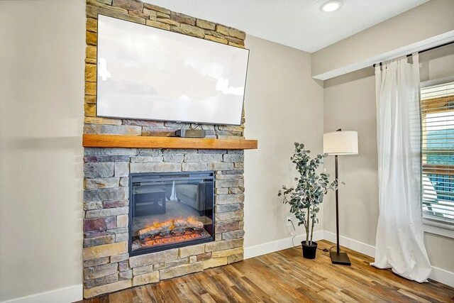 details with a fireplace and hardwood / wood-style flooring