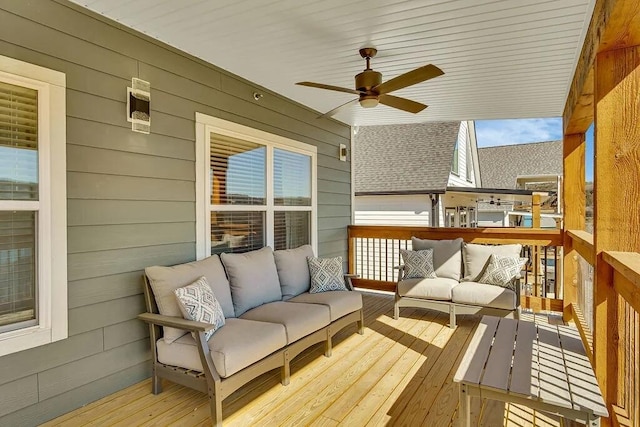 wooden terrace featuring an outdoor living space and ceiling fan