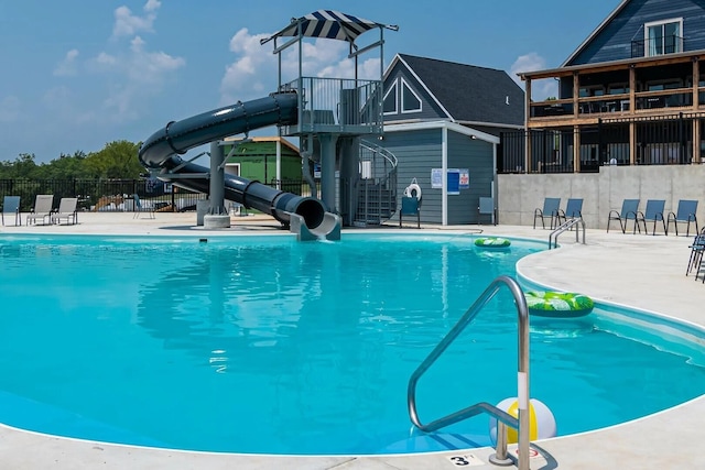 view of swimming pool with a water slide