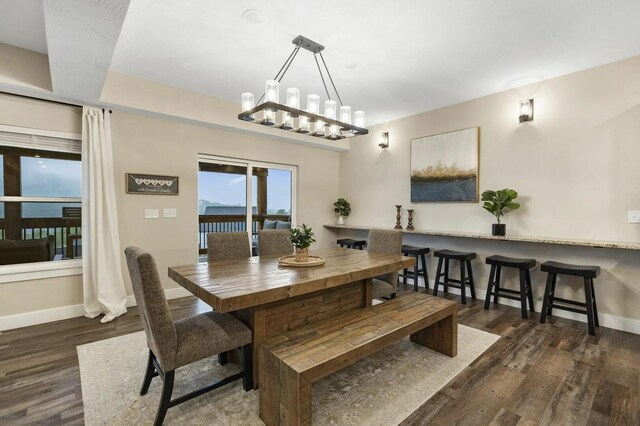 dining space with an inviting chandelier and dark hardwood / wood-style floors