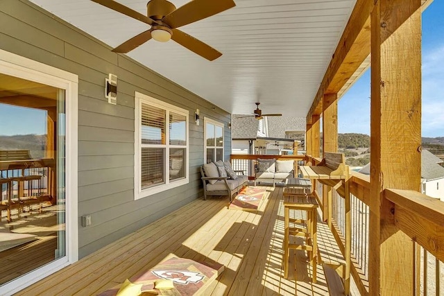 wooden deck featuring ceiling fan