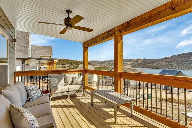 wooden terrace with outdoor lounge area, a mountain view, and ceiling fan