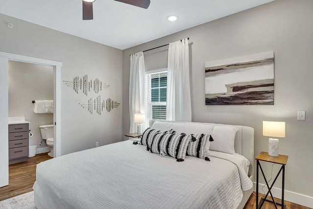 bedroom with hardwood / wood-style floors, connected bathroom, and ceiling fan