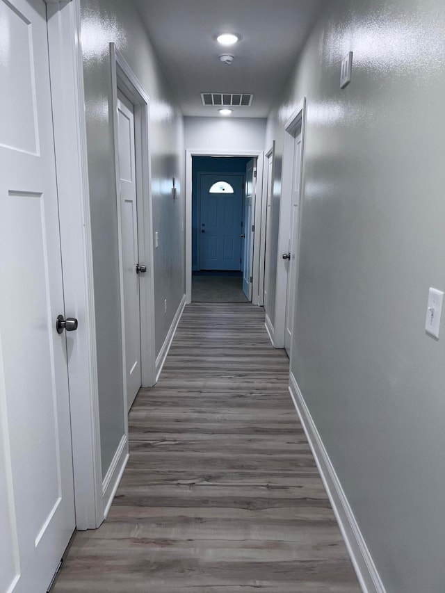 corridor with dark hardwood / wood-style floors