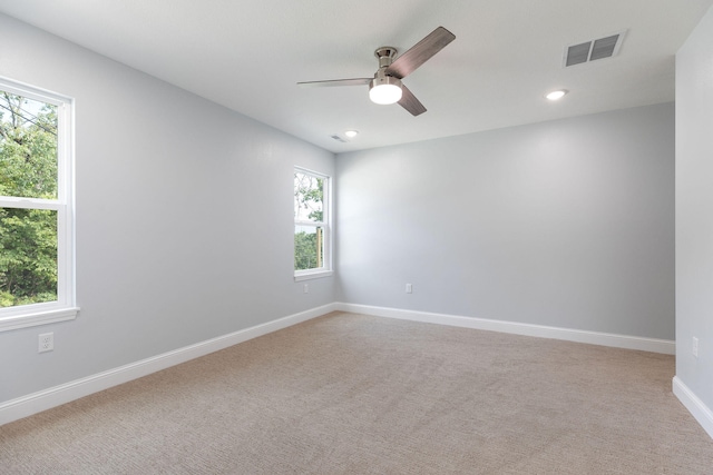 carpeted spare room with ceiling fan