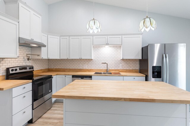 kitchen featuring pendant lighting, white cabinets, appliances with stainless steel finishes, and sink