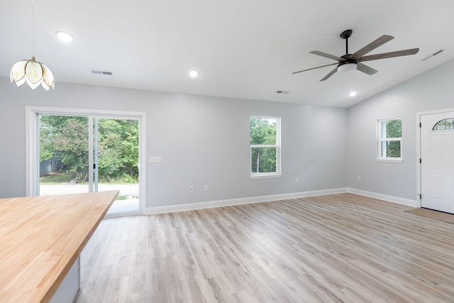 unfurnished living room with lofted ceiling, light wood-type flooring, and ceiling fan