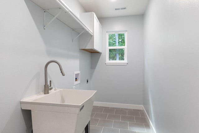 laundry area with hookup for a washing machine, dark tile patterned floors, sink, and hookup for an electric dryer