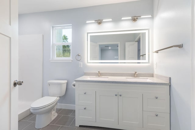 bathroom featuring tile patterned flooring, vanity, and toilet