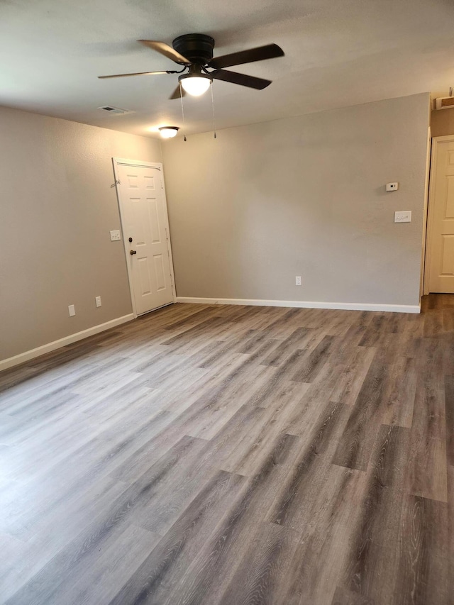 empty room featuring ceiling fan and wood-type flooring