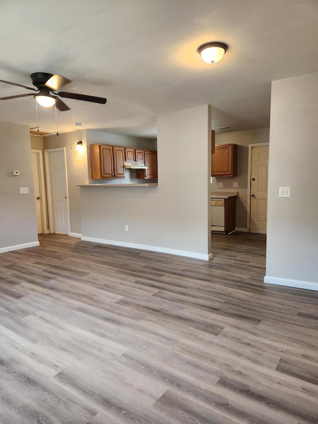 unfurnished living room featuring light wood-type flooring and ceiling fan