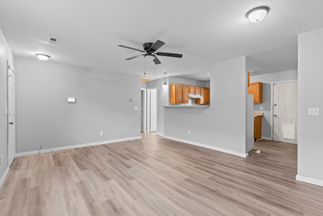 unfurnished living room featuring ceiling fan and light wood-type flooring