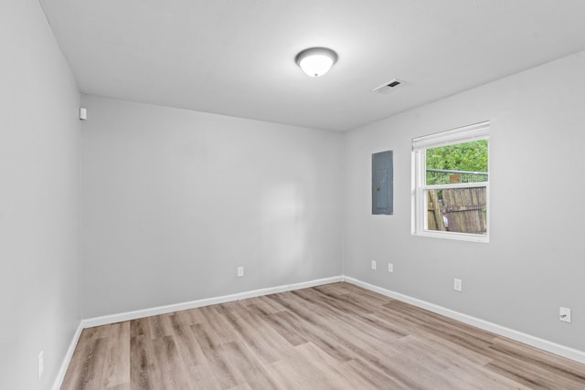 unfurnished room featuring electric panel and light wood-type flooring