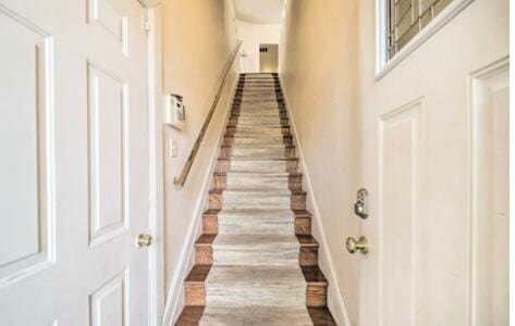 stairway with hardwood / wood-style floors