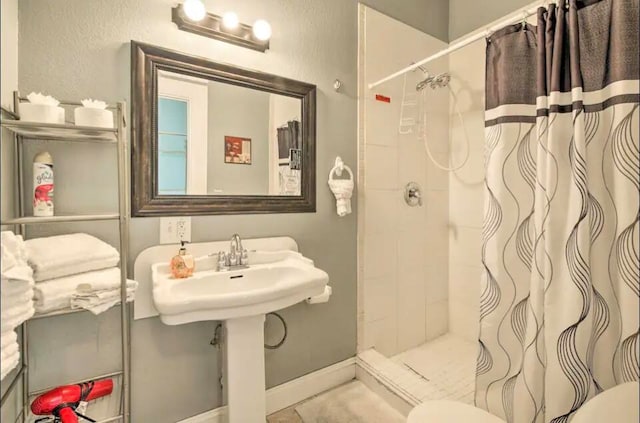 bathroom with toilet and curtained shower