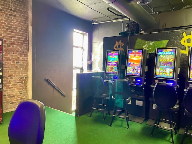 recreation room with brick wall