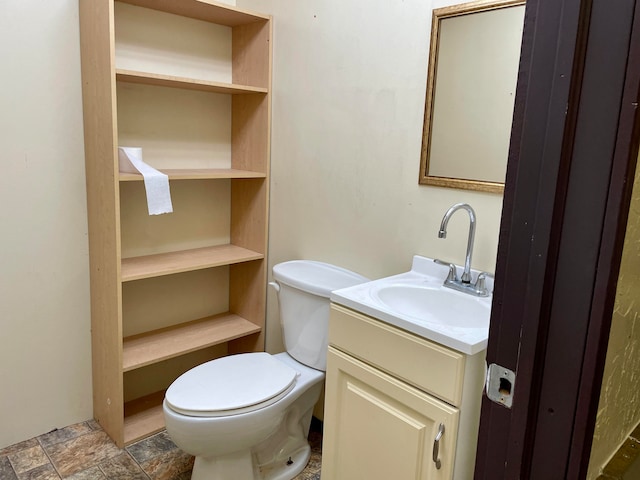 bathroom with toilet and vanity