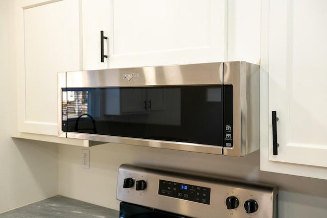 details with white cabinets and stainless steel appliances