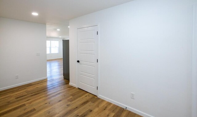 empty room with hardwood / wood-style floors