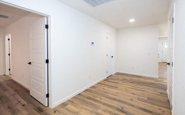 corridor with wood-type flooring