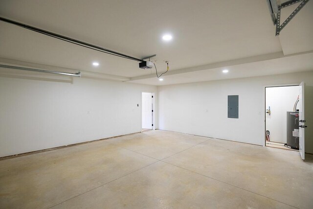 garage with electric water heater, electric panel, and a garage door opener