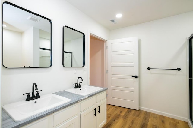 bathroom featuring vanity and hardwood / wood-style flooring