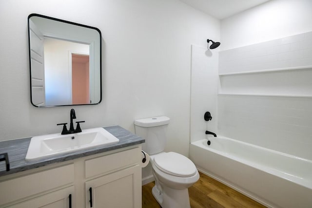 full bathroom with bathing tub / shower combination, toilet, vanity, and hardwood / wood-style flooring