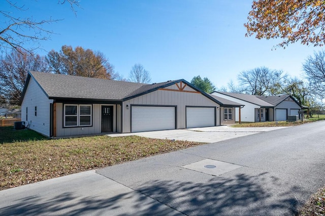 single story home featuring a front yard, a garage, and cooling unit