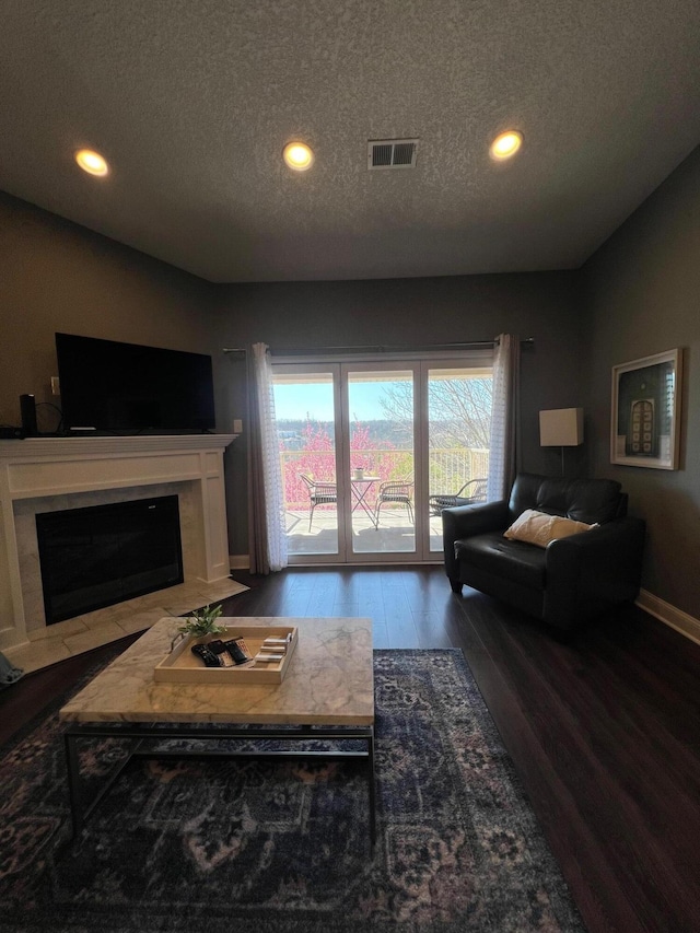 living room featuring a textured ceiling and hardwood / wood-style flooring