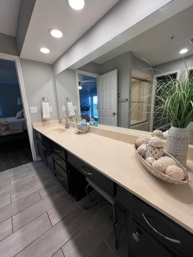 bathroom featuring wood-type flooring, vanity, and walk in shower