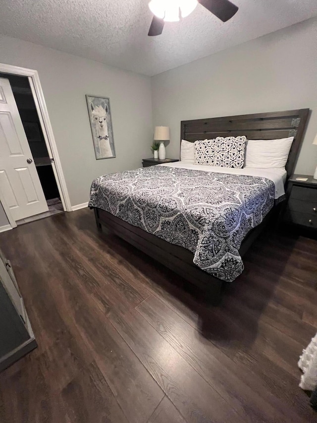 bedroom with hardwood / wood-style flooring, ceiling fan, and a textured ceiling