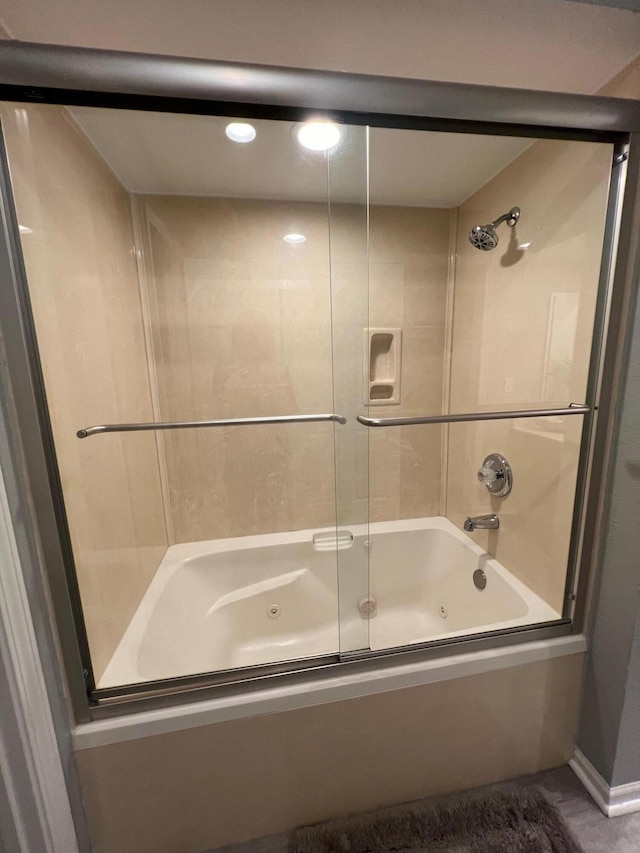 bathroom with shower / bath combination with glass door