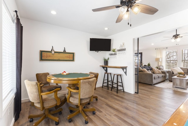 dining space with ceiling fan and wood-type flooring