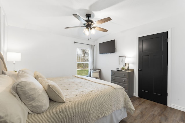 bedroom with ceiling fan and dark hardwood / wood-style flooring