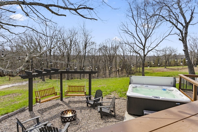 view of yard featuring an outdoor fire pit and a hot tub