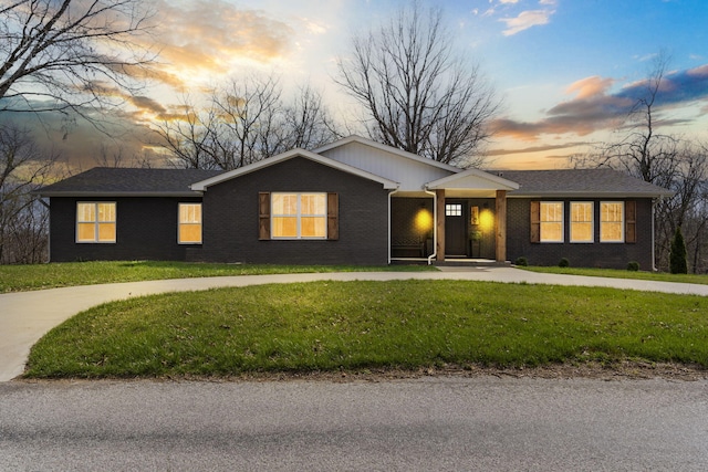 ranch-style house featuring a lawn