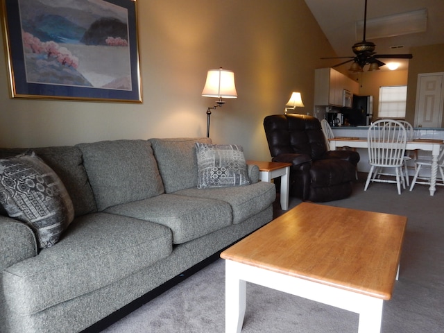 living room with high vaulted ceiling, carpet flooring, and ceiling fan