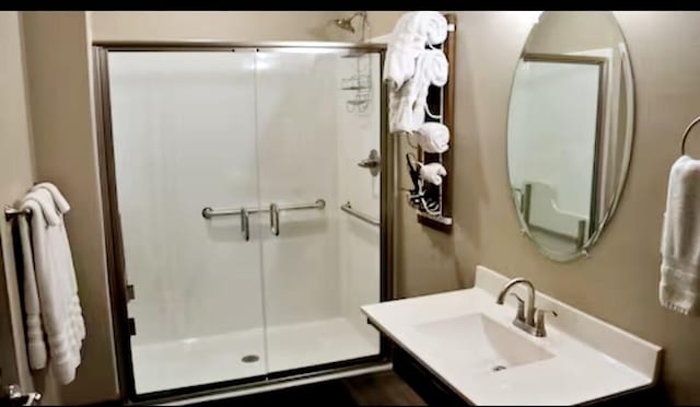 bathroom featuring vanity and an enclosed shower