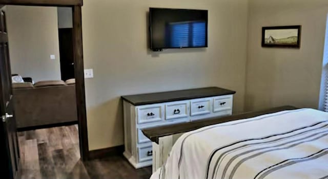 bedroom with dark wood-type flooring