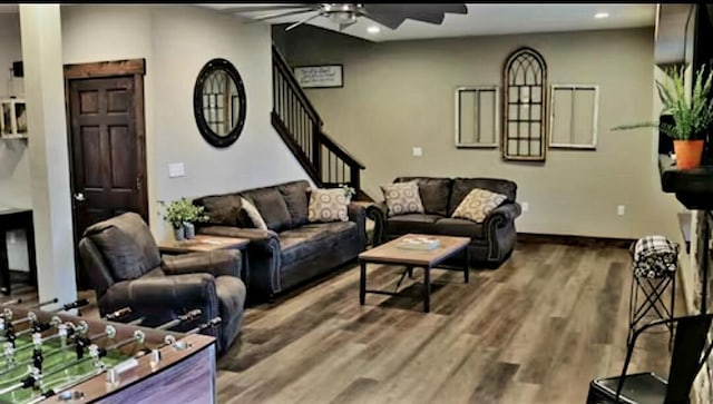 living room featuring wood-type flooring and ceiling fan